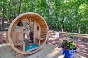 a small wooden hobbit house on a deck at Breathtaking Treehouse with Barbecue and Hot-tub in Scottsboro, Alabama in Grant