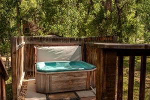 a wooden hot tub in a wooden fence at Beautiful Secluded Cabin with a Hot Tub near Monarch Mountain in Colorado in Monarch