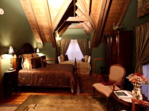 a bedroom with a bed and a chair in it at Rustic Room Rental for a Vacation near Harrison, Arkansas in Ponca
