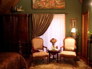 a bedroom with two chairs and a table and a bed at Rustic Room Rental for a Vacation near Harrison, Arkansas in Ponca