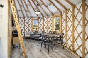 a room with a table and chairs in a yurt at Secluded Off-Grid Yurt with Forest Views Near Trails in Sears, Michigan in Sears