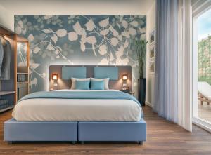 a bedroom with a large bed with a floral wall at Hotel Castello in LʼAquila