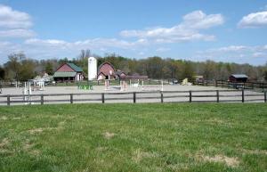 a park with a fence in front of a farm at 1856 Manor Vacation Rental on Huge Horse and Cattle Farm near Charlottesville, Virginia in Gordonsville