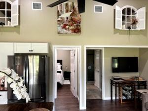 a living room with a refrigerator and a bedroom at Comfy Equipped Lodge Great for a Peaceful Getaway in Texas in Waelder