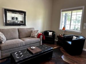 a living room with a couch and a table at Comfy Equipped Lodge Great for a Peaceful Getaway in Texas in Waelder