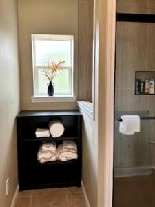 a small bathroom with a window and towels at Comfy Equipped Lodge Great for a Peaceful Getaway in Texas in Waelder