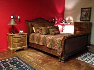 a bedroom with a bed and a red wall at Western-Style Bunkhouse with Scenic, Desert Trails near Scottsdale, Arizona in Tonto Hills Subdivision