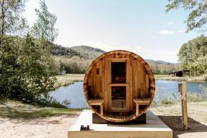 a wooden boat sitting on a dock next to a lake at Outstanding Safari Tent with Fire Pit and Nice Sights in North Woodstock, New Hampshire in Woodstock