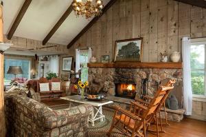 a living room with a couch and a fireplace at Romantic Country Getaway with Wood-Burning Fireplace near Houston, Texas in Cat Spring