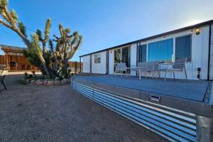 a house with a deck with a table on it at Stunning Vacation Rental with Foosball and Barbecue in Meadview, Arizona in Meadview
