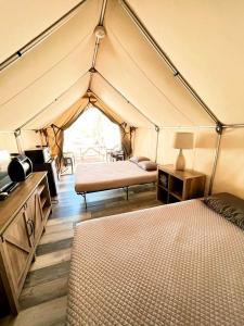 a room with two beds in a tent at Charming Safari Tent on the San Marcos River near Kingsbury, Texas - Perfect for an Aquatic Adventure in Staples