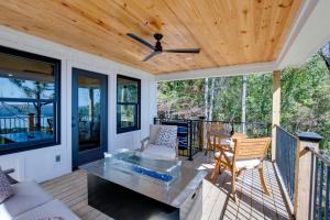 a screened porch with a wooden ceiling and a table at Gorgeous Cabin Great for Groups or Families with Jacuzzi, Fire Pit and Views in Alabama in Grant