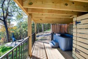 a wooden deck with a hot tub on a porch at Gorgeous Cabin Great for Groups or Families with Jacuzzi, Fire Pit and Views in Alabama in Grant +35 photos