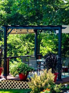 a pergola with chairs and plants on a patio at Bed and Breakfast Perfect for a Romantic Getaway near Camden Hills State Park, Maine in Lincolnville