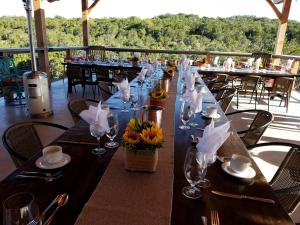 a long table with wine glasses and flowers on it at Entire Property Rental for Large Groups Sleeping 40+ Guests with Pool and Fire Pit in Texas Hill Country near Austin, Texas in Hammetts Crossing