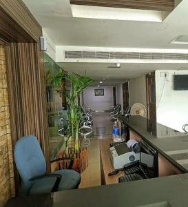 a living room with a view of a room with a living room at M k residency in Ernakulam