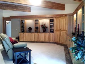 a living room with a couch and wooden cabinets at Amazing Mountainside Vacation Rental with Private Hot Springs in Hamilton, Montana in Darby