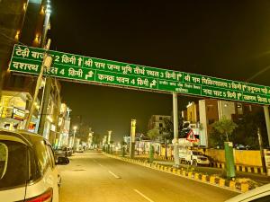 a sign over a street in a city at night at Hotel Vaidik Vedas Suites At Ram Mandir Ayodhya in Ayodhya