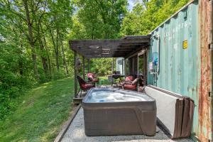a tub sitting on the side of a house at Unique Dover Accommodation with a Hot Tub Perfect for Glamping in Ohio in Mineral City
