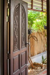 an entrance door to a garden with a fence at House 4 people sea view 100 m from the beach in Klong Muang Beach