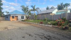 a house with a blue roof and a yard at Shavia Home in Arusha