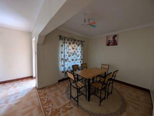 a dining room with a table and chairs at Shavia Home in Arusha