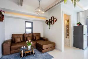 a living room with a brown couch and a refrigerator at Pool Villa Suchada 3 bedrooms max 7 peoples in Ban Khlong Haeng