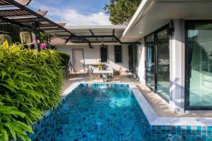 a swimming pool in the yard of a house at Pool Villa Suchada 3 bedrooms max 7 peoples in Ban Khlong Haeng