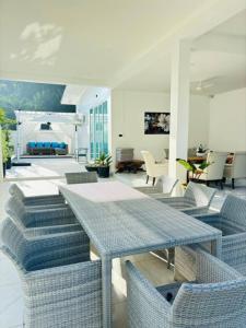 a living room with blue tables and chairs at Baan Suan pool valley Villa in Ban Nong Thale