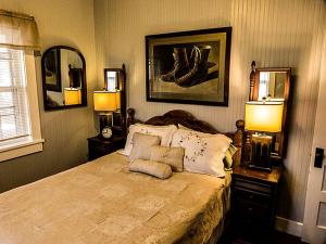 a bedroom with a bed with two lamps on it at Charming Glamping Rental with Fireplace near Great Smoky Mountains National Park in Greeneville