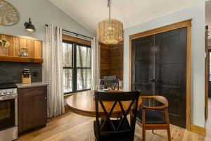 a kitchen with a table and chairs in a room at Lakefront Cabin with Fire Pit in Carbondale, Illinois in Makanda +35 photos