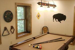 a pool table in a room with a pig on the wall at Romantic One-Bedroom Cabin with a Fireplace near Asheville, North Carolina in Crabtree +7 photos