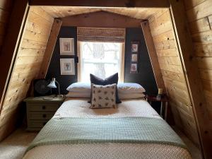 a bedroom with a bed in a small room at Cozy Rustic Cabin in the Prescott National Forest near Lynx Lake in Prescott, Arizona in Walker