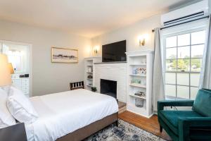 a bedroom with a bed and a fireplace at Elegant Historic Suite with Mountain Views in Luray, Virginia in Luray