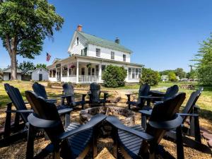 a group of chairs sitting in front of a house at Elegant Historic Suite with Mountain Views in Luray, Virginia in Luray