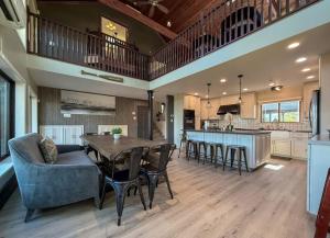 a kitchen and living room with a table and chairs at Luxurious Villa with Hot-tub, Fire Pit and Games in Gary, Indiana in Miller