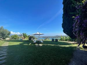 a park with an umbrella in the grass at Agriturismo Valsiniga - Your Private Family Retreat on Lake Garda Saló in Salò