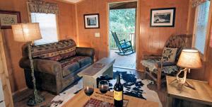a living room with a couch and a table at Secluded Cabin Perfect for a Romantic Getaway in Austin County, Texas in Cat Spring