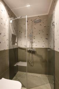a bathroom with a shower with a glass door at Dimi Residence in Nea Moudania +48 photos
