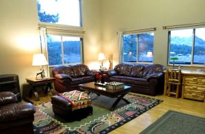 a living room with leather couches and a coffee table at Impressive Cabin Rental with Views of Pike National Forest near Colorado Springs, Colorado in Westcreek +22 photos