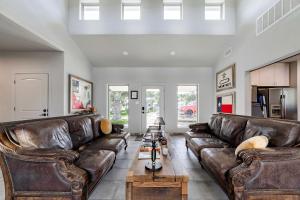 a living room with brown leather couches and a table at Fabulous Cozy Airstream Perfect for a Small Family Unique Escape in Texas in Spicewood