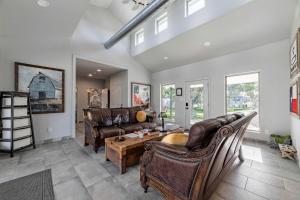 a living room with leather furniture and a table at Fabulous Cozy Airstream Perfect for a Small Family Unique Escape in Texas in Spicewood