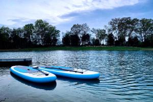 two boats are sitting in the water on a lake at Tiny House Cabin in Marion, IL in Sunset Harbor