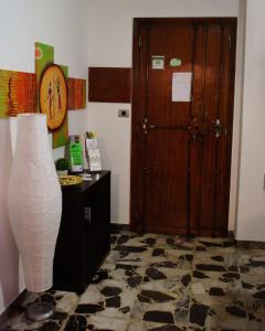 Zimmer mit einer Tür und einer Vase auf einer Etage in der Unterkunft Un Letto a Casteddu in Cagliari