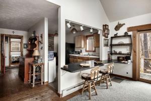 a kitchen with a counter and chairs in a room at Lustrous Lakefront Cabin Oasis near Lake Ferndale in West Virginia in Springfield
