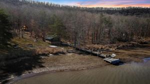 an aerial view of a house next to a river at Lustrous Lakefront Cabin Oasis near Lake Ferndale in West Virginia in Springfield