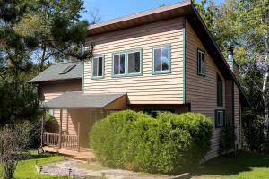 a small house with a porch at Lakefront Cabin Rental with a Paddle Boat near Wisconsin Dells, Wisconsin in Tomah +25 photos