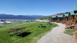 a group of picnic tables on the grass near a marina at Impressive Cabin with Gorgeous Lake Vistas near West Yellowstone, Montana in Lakeview