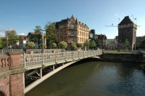 a bridge over a river in a city with buildings at MAVO Hospitality Esslingen Bahnhofstraße in Esslingen