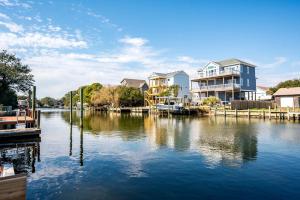 a view of a river with houses and a dock at Gorgeous Waterfront Vacation Rental for an Unforgettable Family Getaway in Frisco, North Carolina in Frisco +72 photos